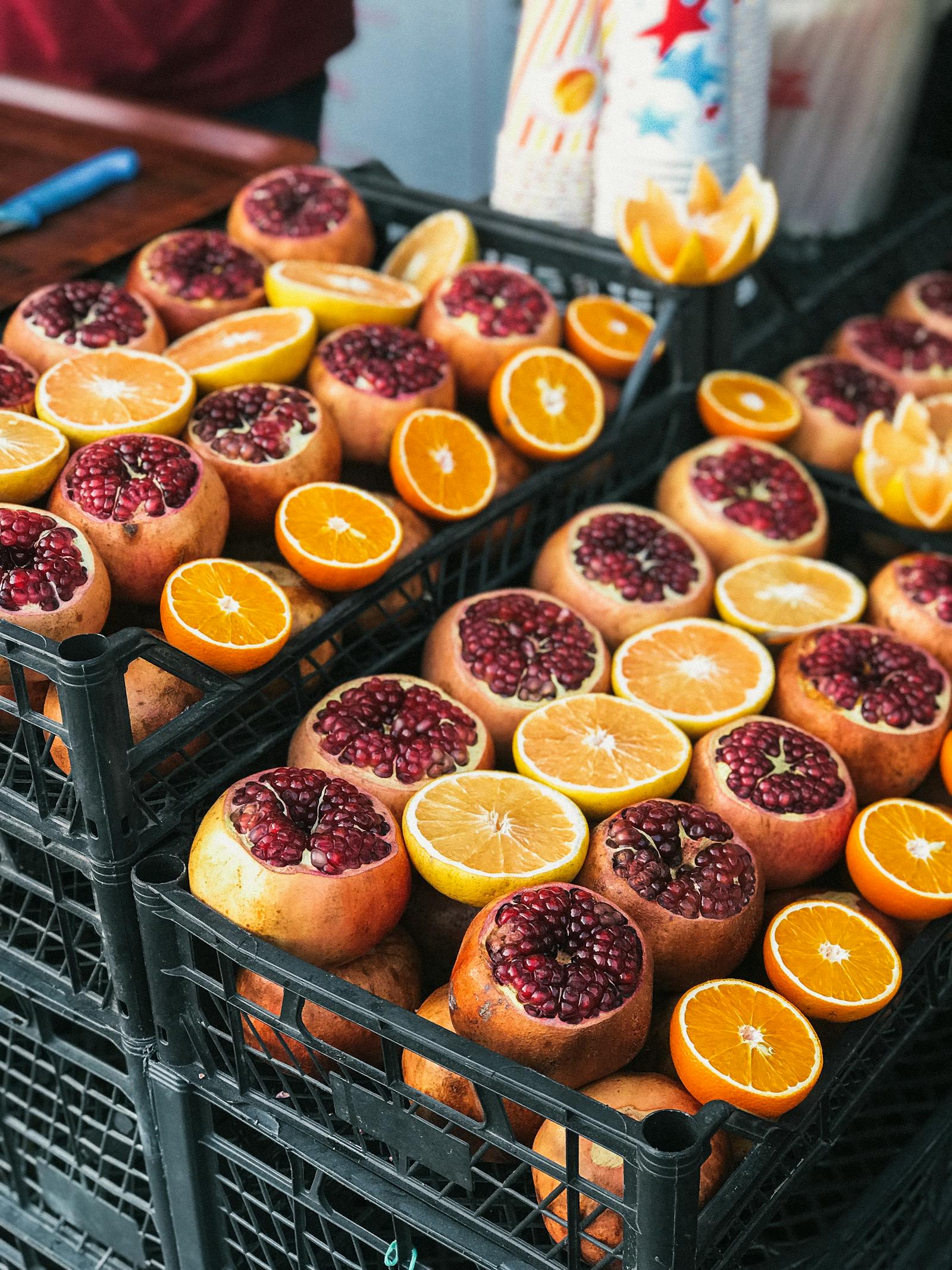Pomegranates and citrus packed in market crates